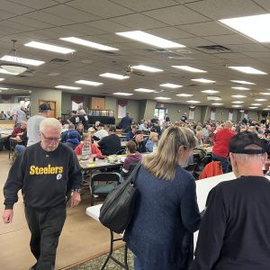 Attendants sitting, walking and talking at a gun bash